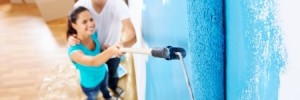 Couple painting the wall Blue