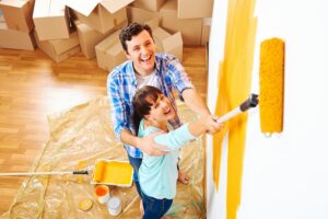 young couple painting walls of their home
