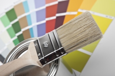 paintbrush with paint color options behind it