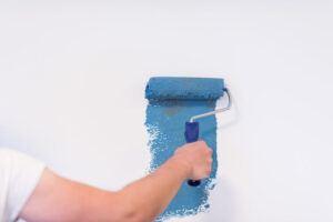 Decorator's hand painting wall with roller