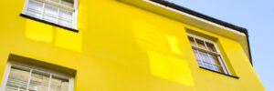 Part of the exterior of a yellow townhouse